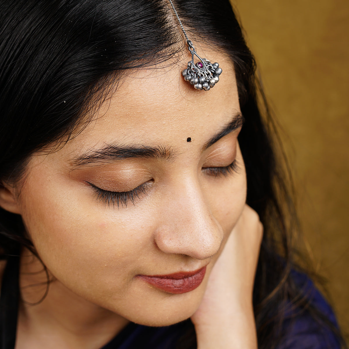 a close up of a person wearing a head piece