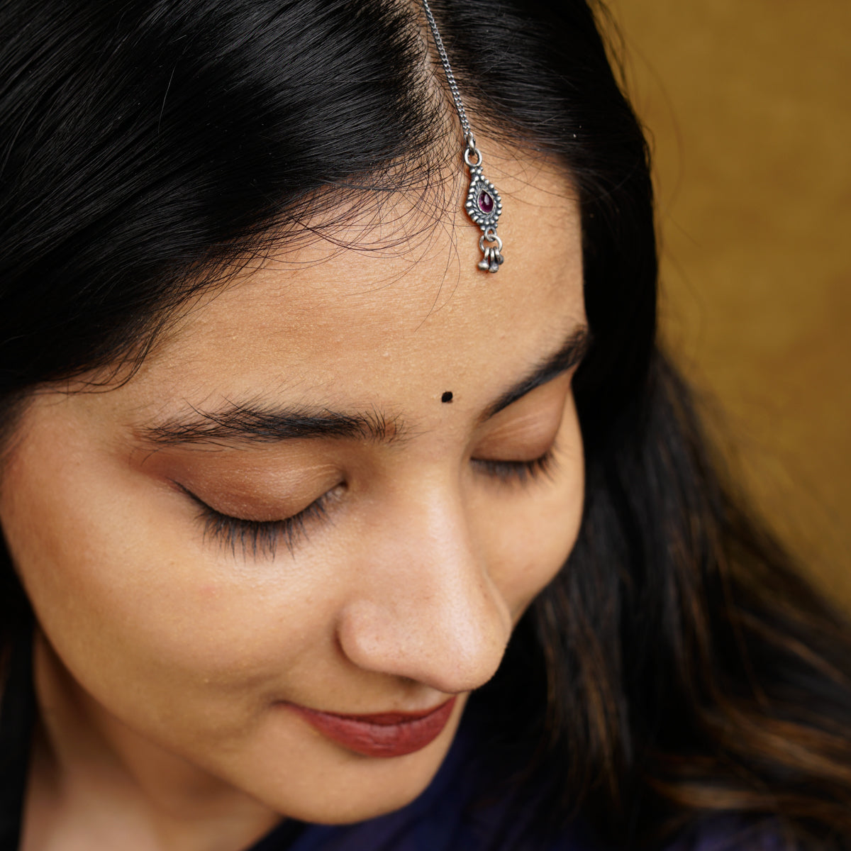 a close up of a person wearing a head piece