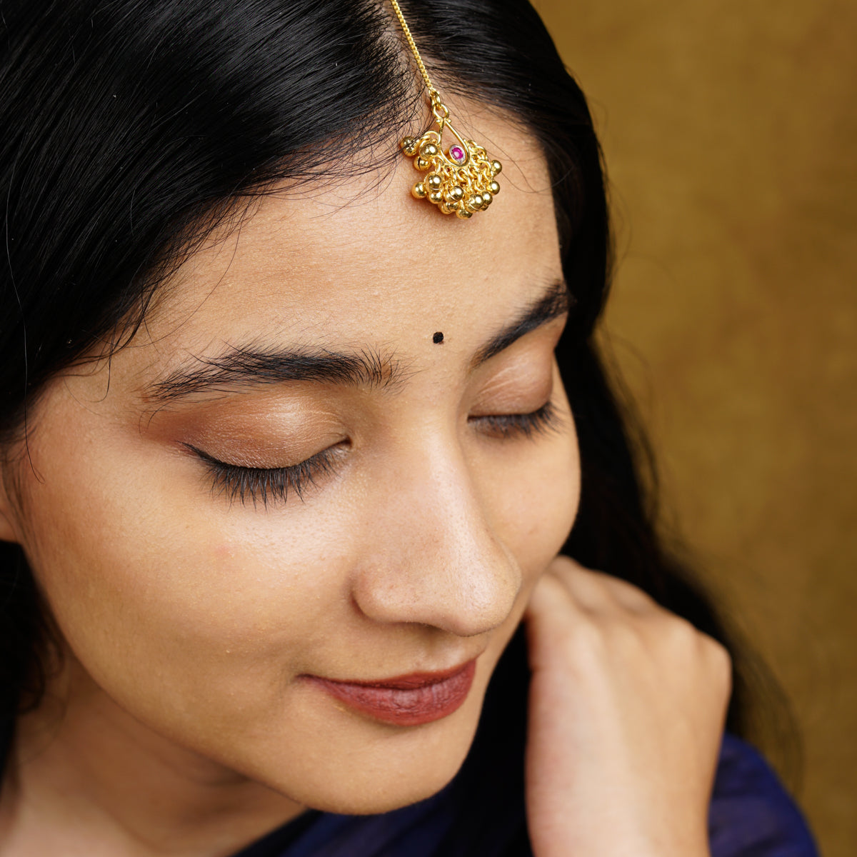 a close up of a woman wearing a head piece