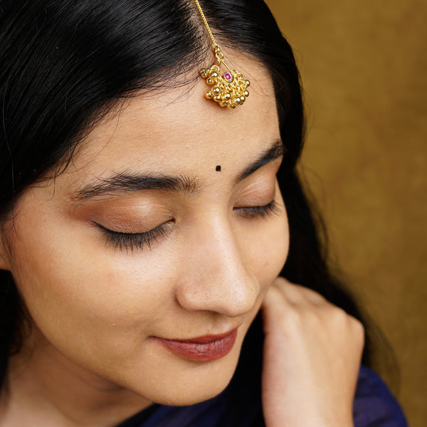 a close up of a woman wearing a head piece