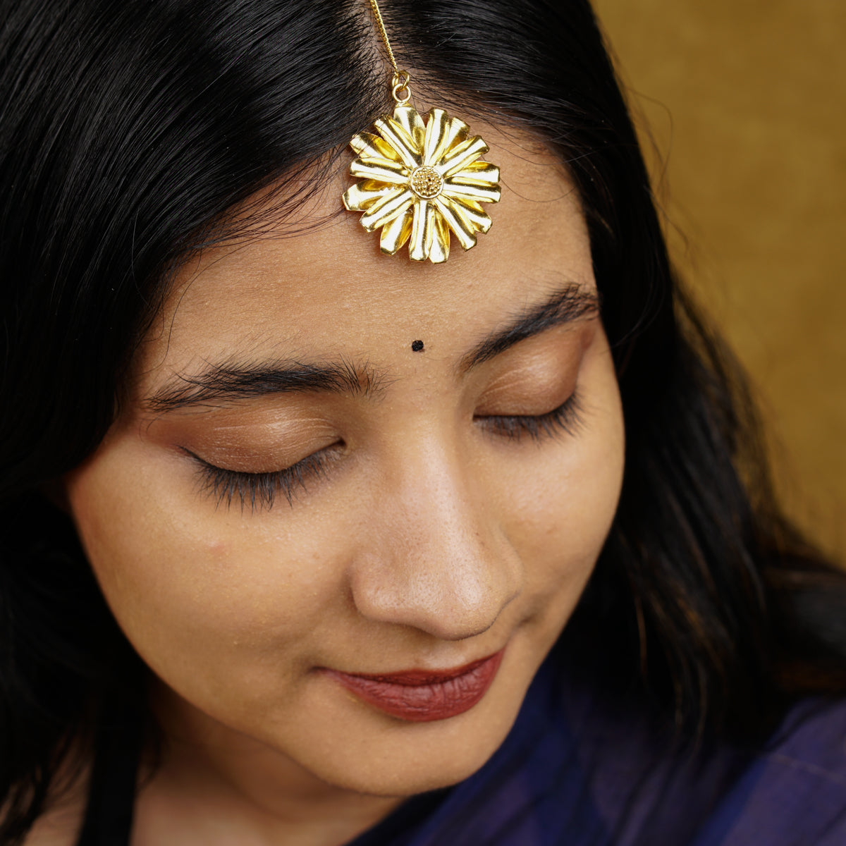 a close up of a person wearing a head piece