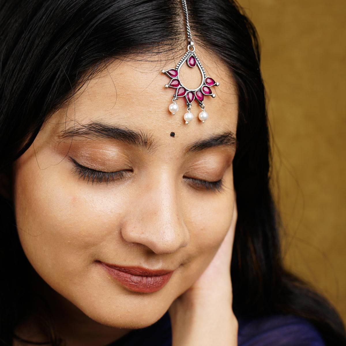 a close up of a woman wearing a head piece