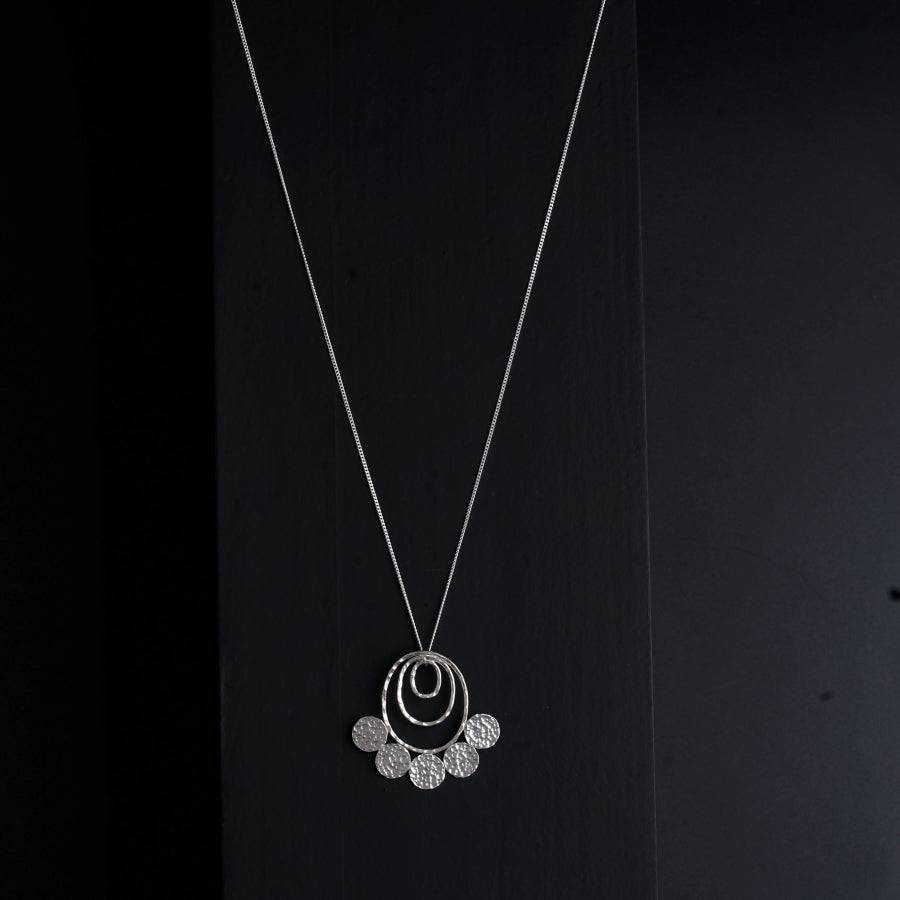 a necklace that has a circle on it