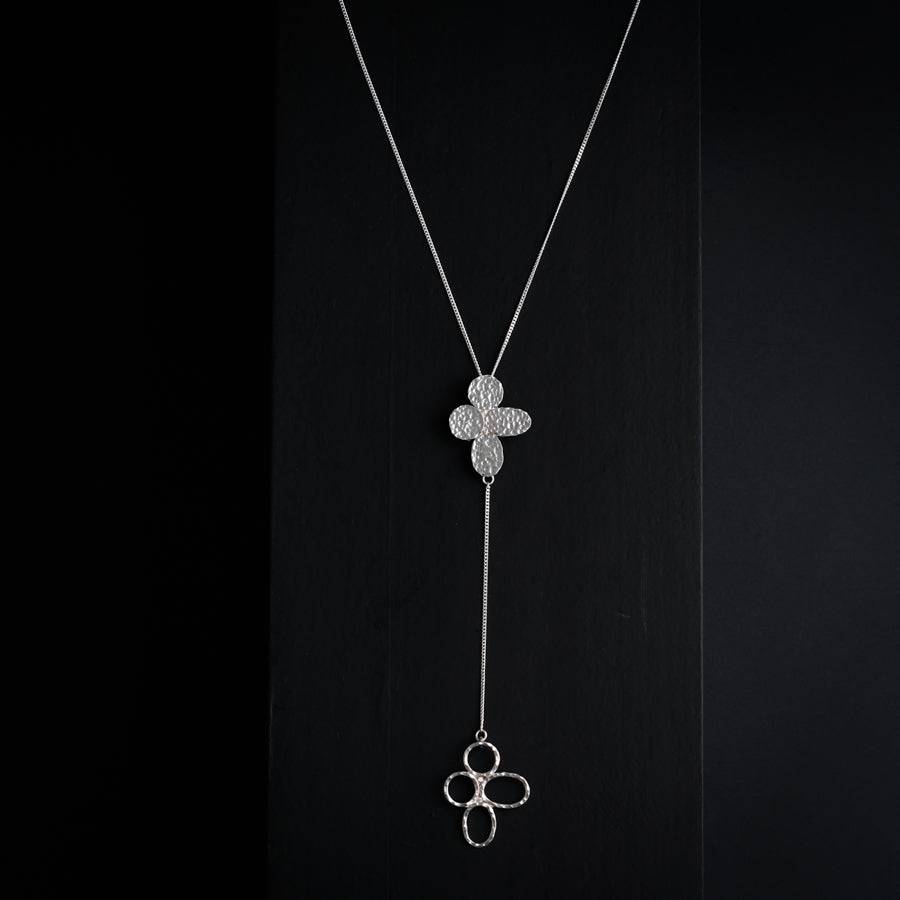 a necklace with a clover on a chain