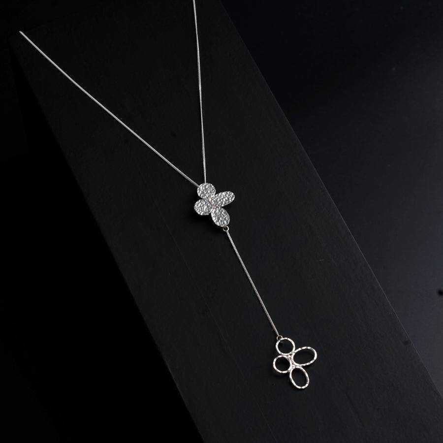 a necklace with a flower on a chain