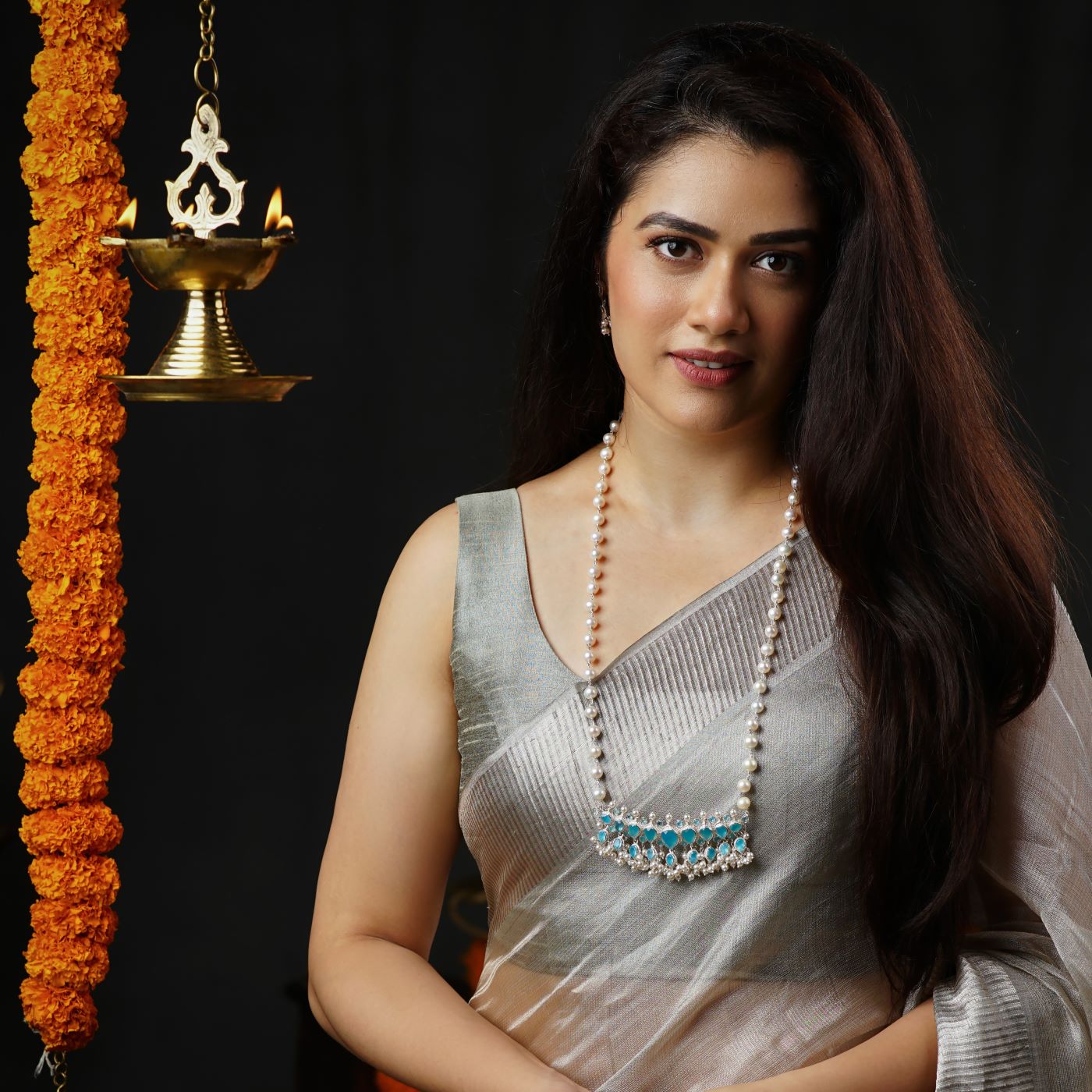 a woman in a sari and a necklace