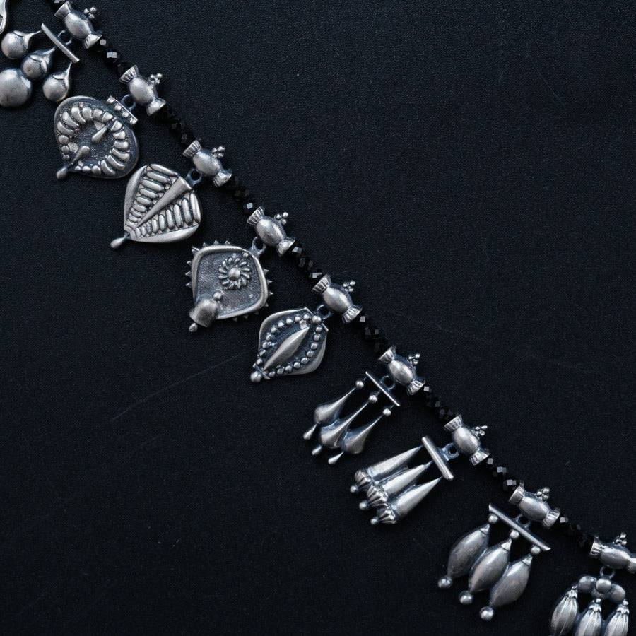 a necklace with a bunch of silver objects on it