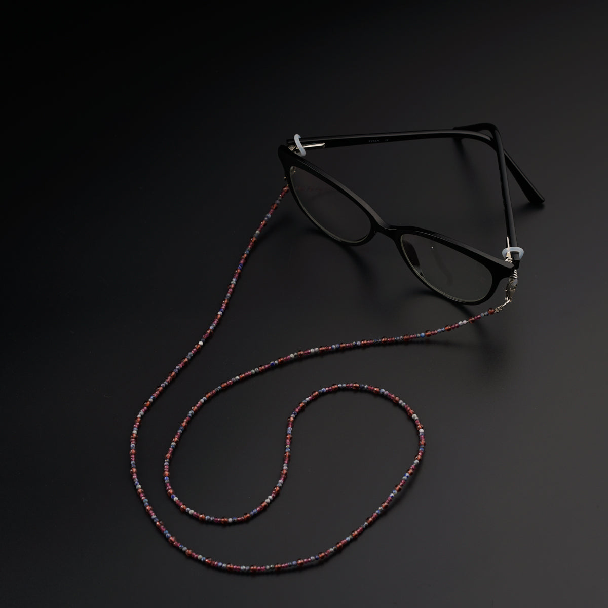 a pair of glasses sitting on top of a black surface