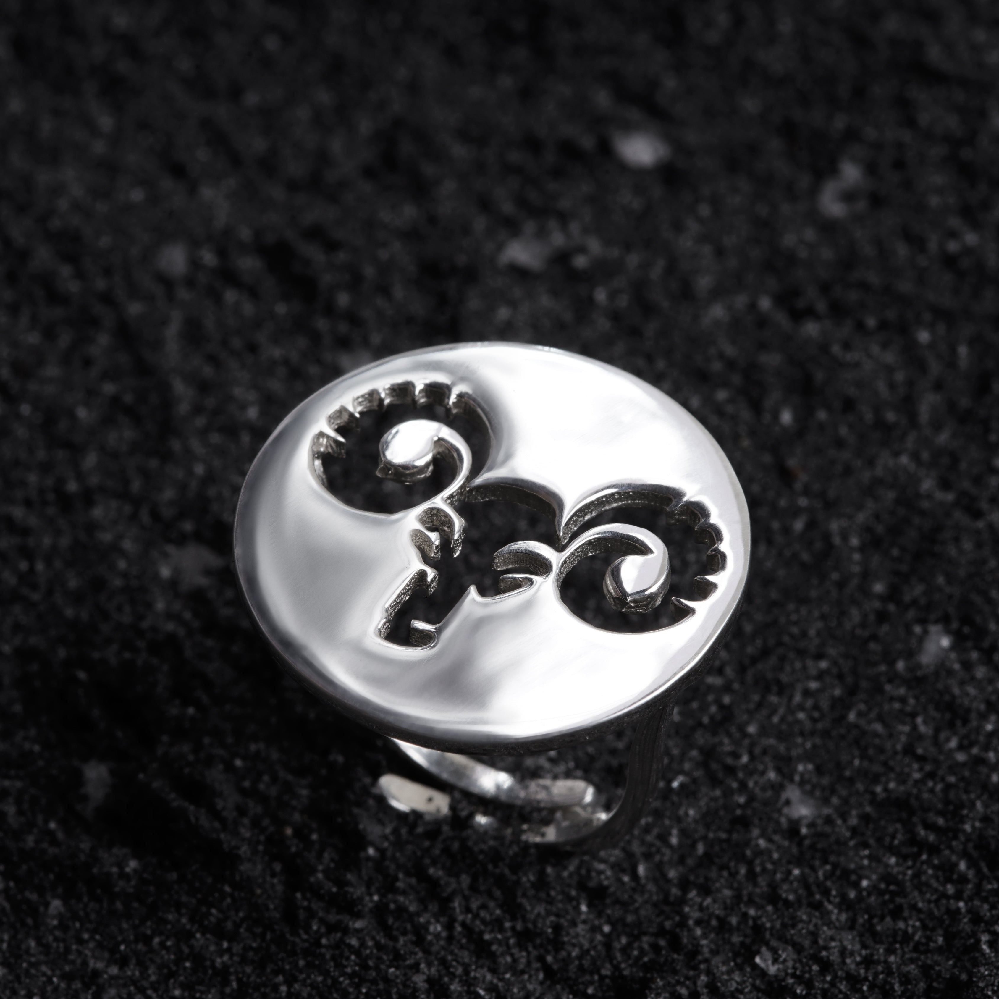 a close up of a ring on a black surface