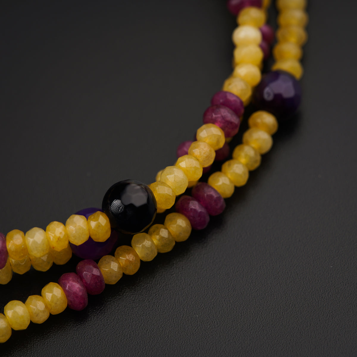 a close up of a multi colored beaded necklace