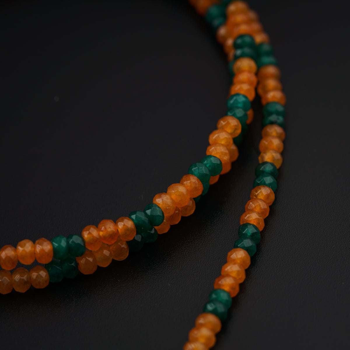 a close up of a necklace with beads