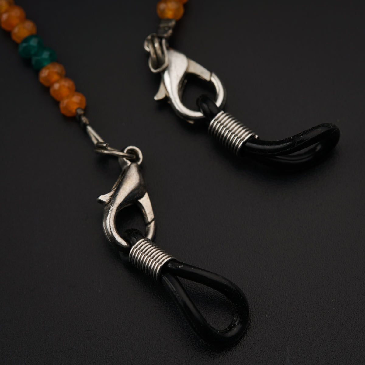 a close up of a pair of scissors on a beaded necklace