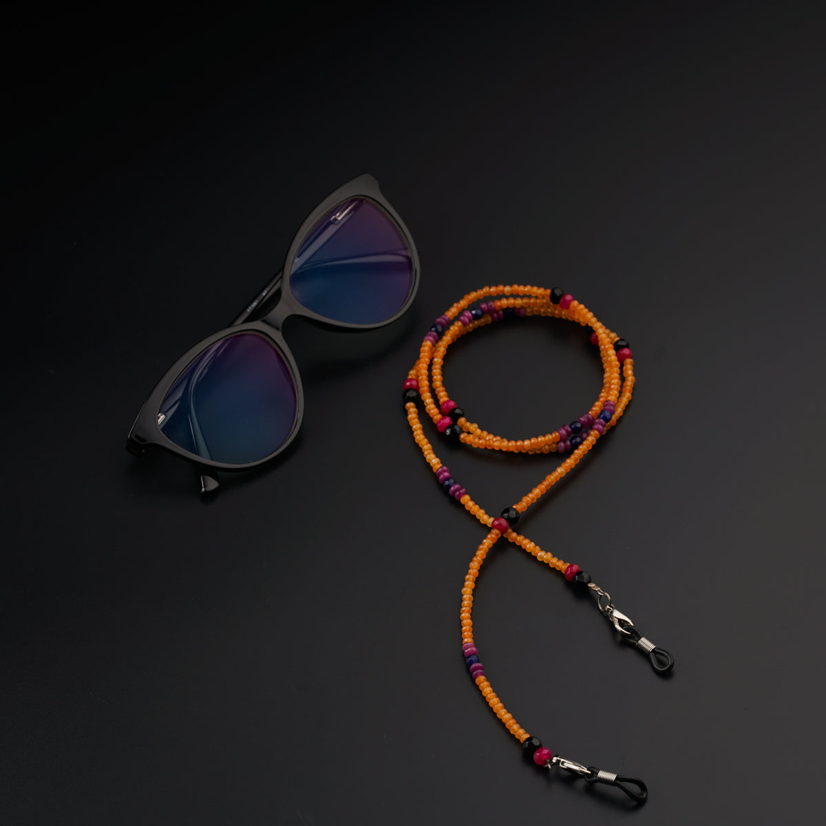 a pair of sunglasses and a beaded lanyard