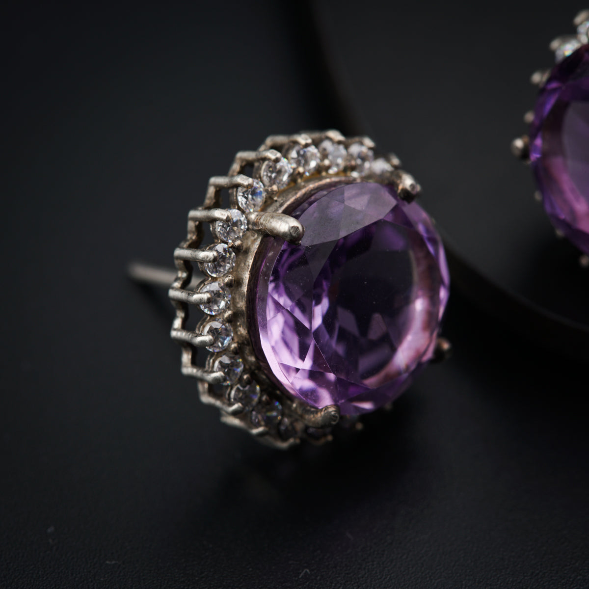 a pair of amethyst colored stone earrings