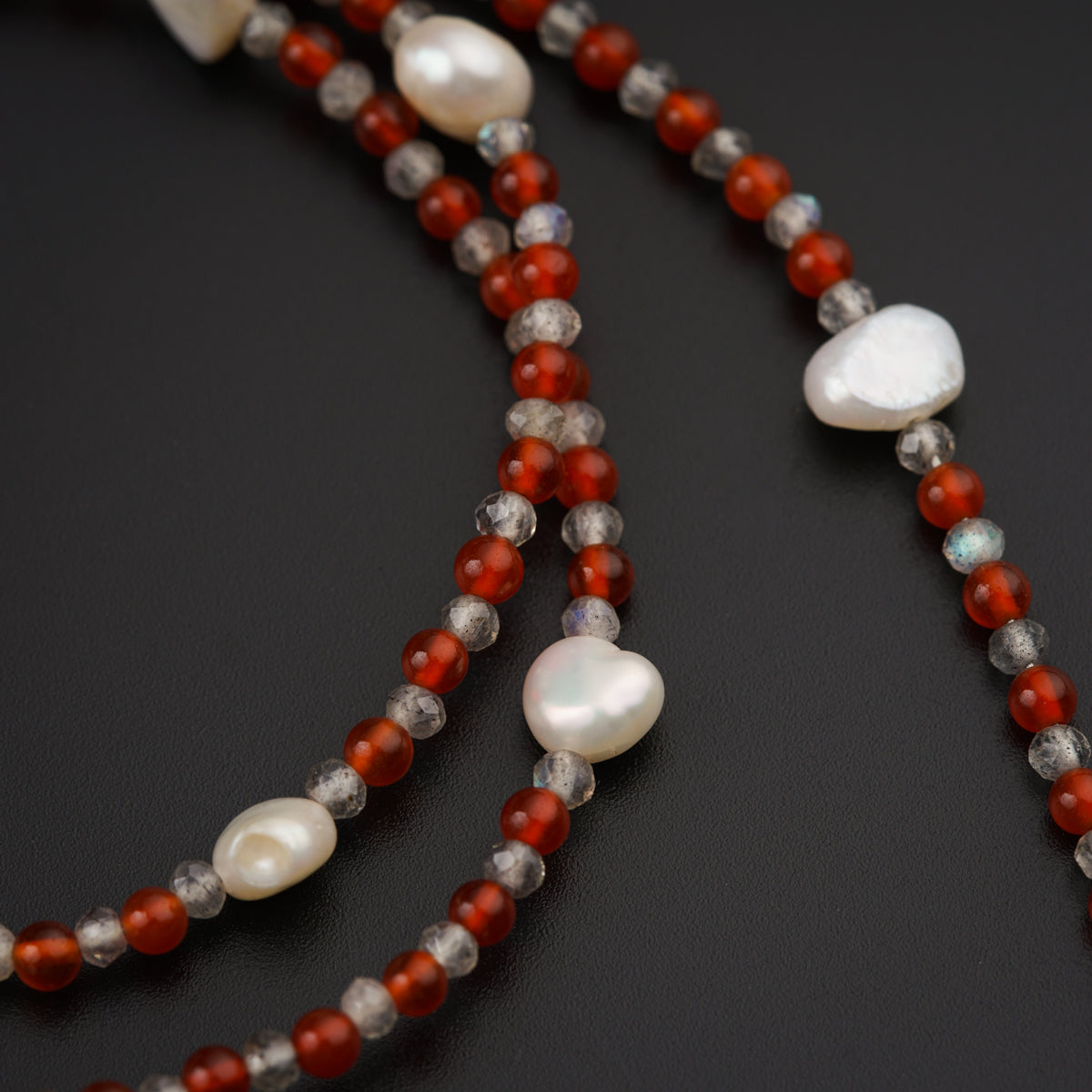 a long necklace with red and white beads