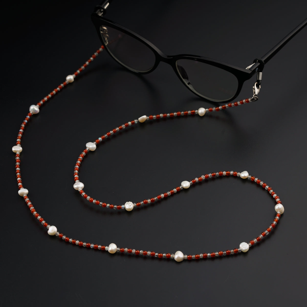 a pair of glasses and a beaded necklace