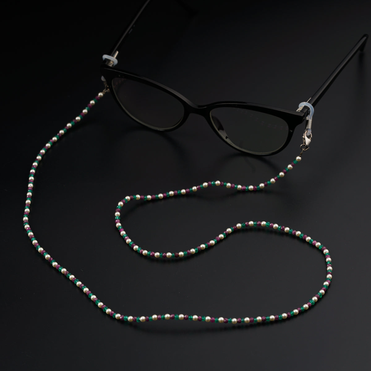 a pair of sunglasses and a beaded necklace
