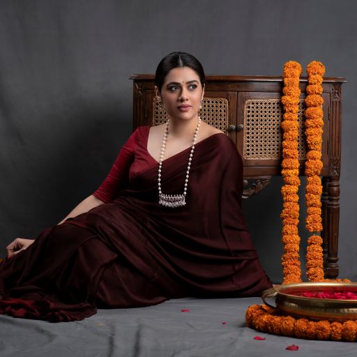 a woman in a red dress sitting on a table