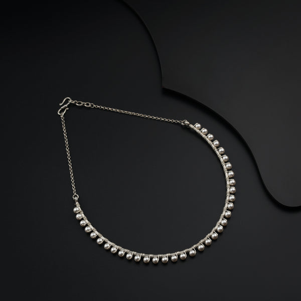 a close up of a necklace on a black surface