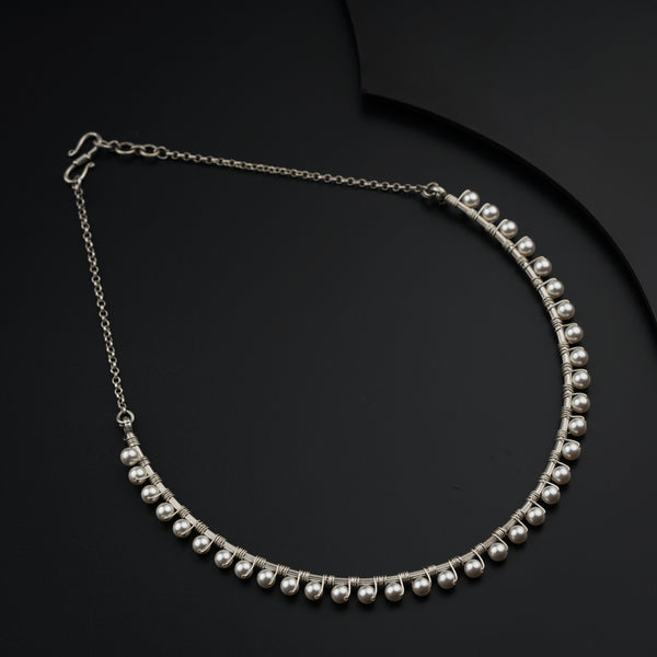 a close up of a necklace on a black surface