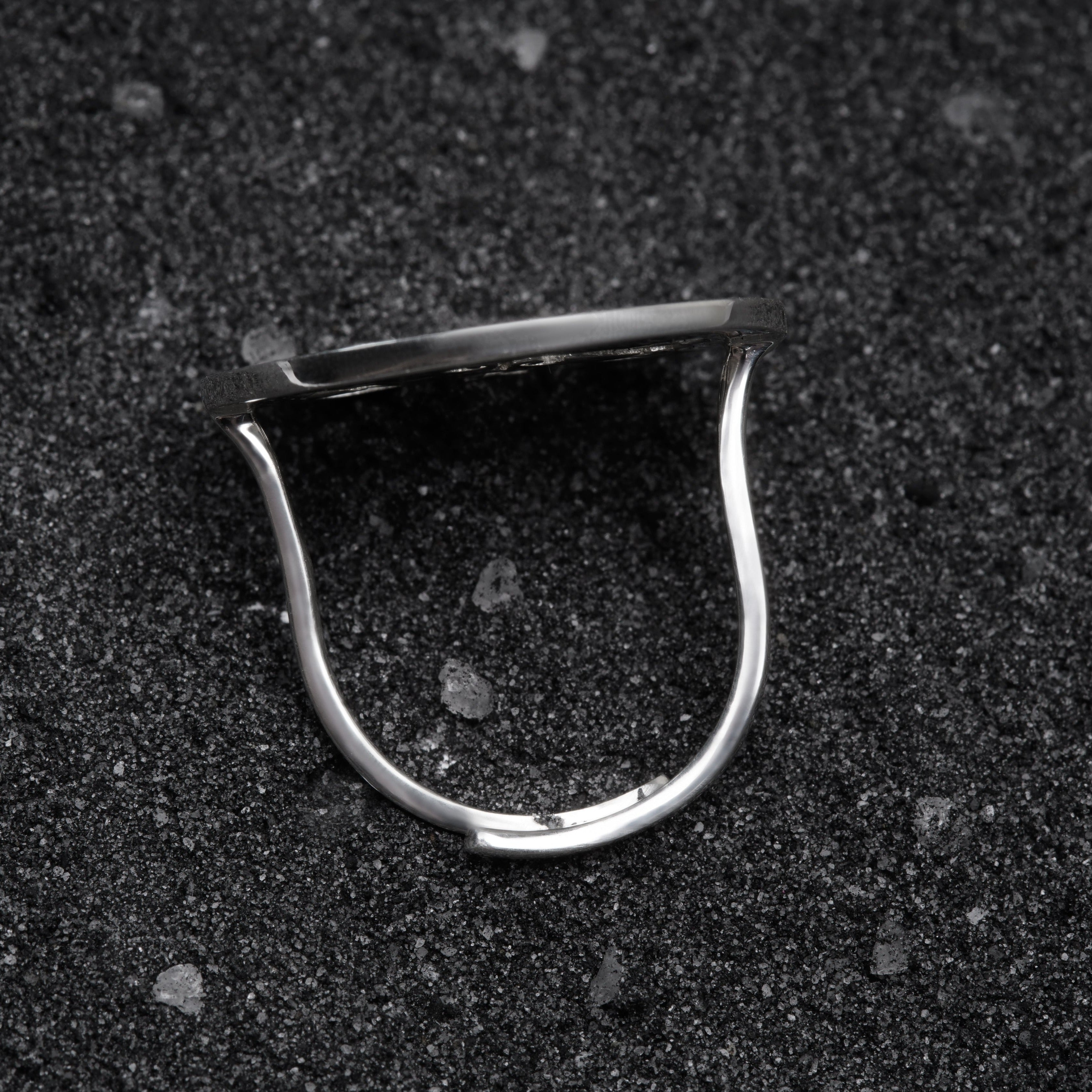 a close up of a metal object on a black surface