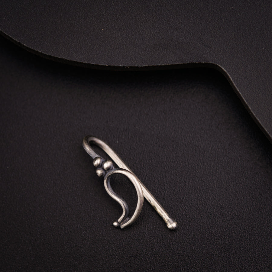 a close up of a metal object on a black surface