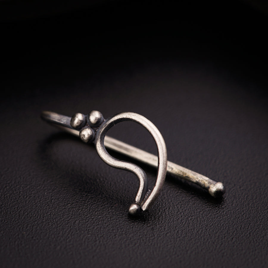 a close up of a metal object on a black surface