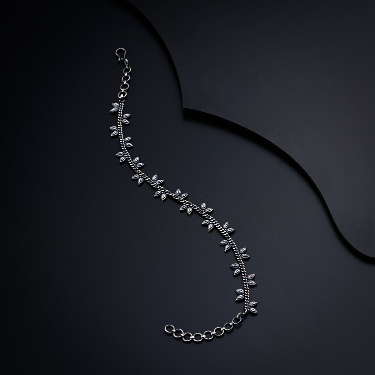a silver necklace with a long chain