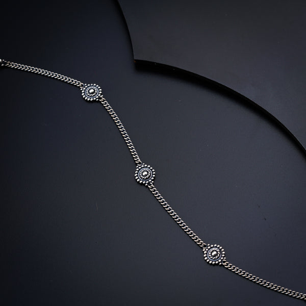 a close up of a necklace on a black surface