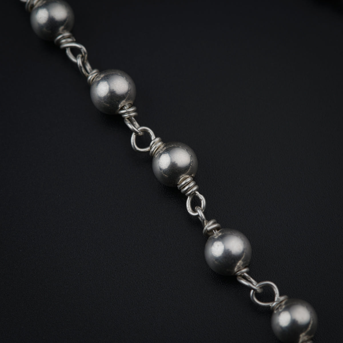 a close up of a chain on a black surface
