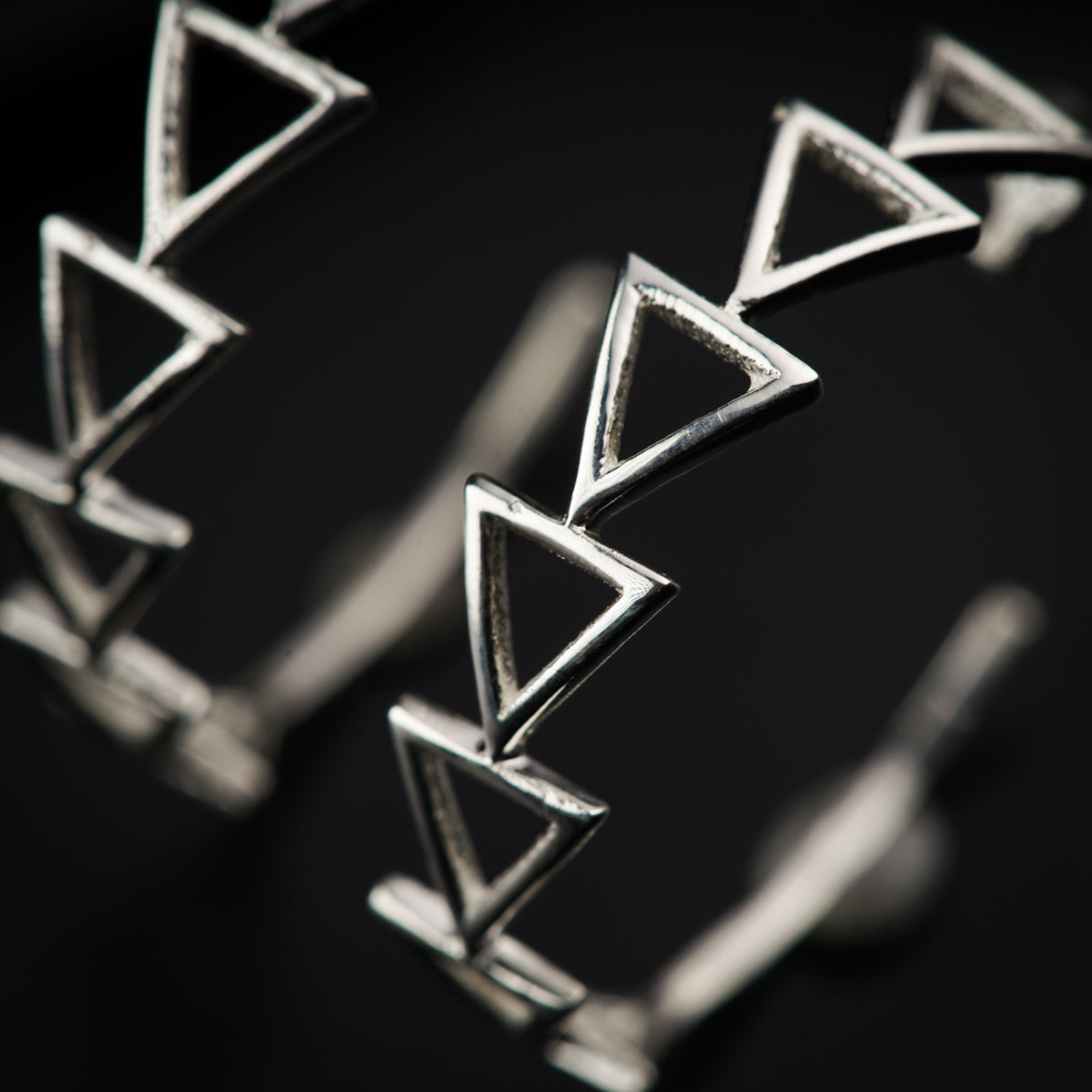 a close up of a metal object with a black background