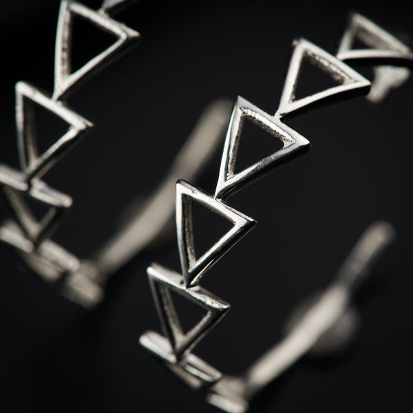 a close up of a metal object with a black background