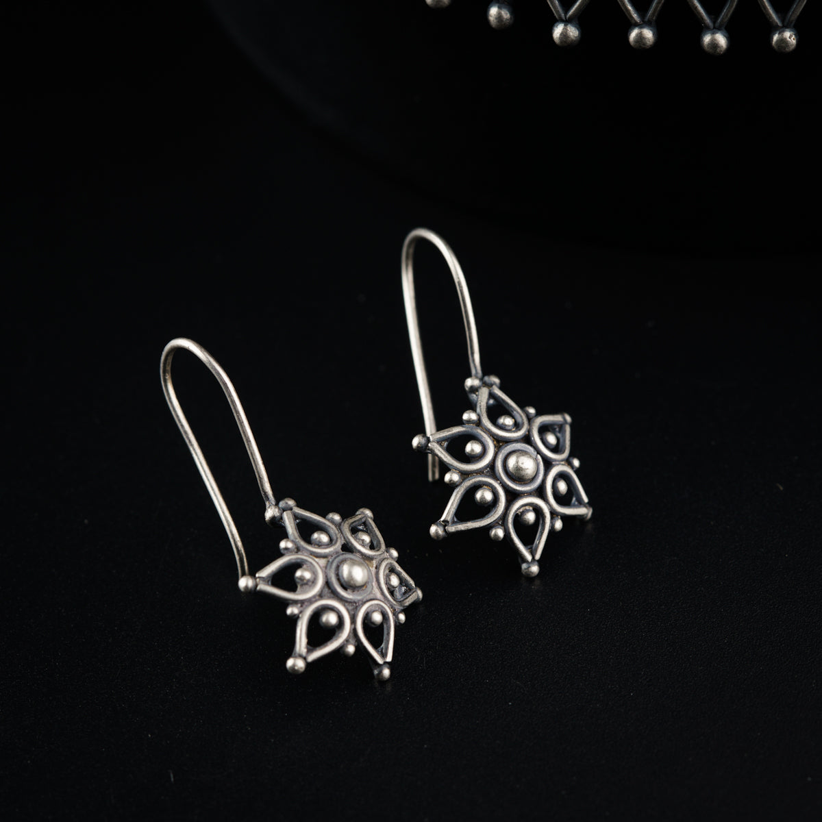 a pair of earrings sitting