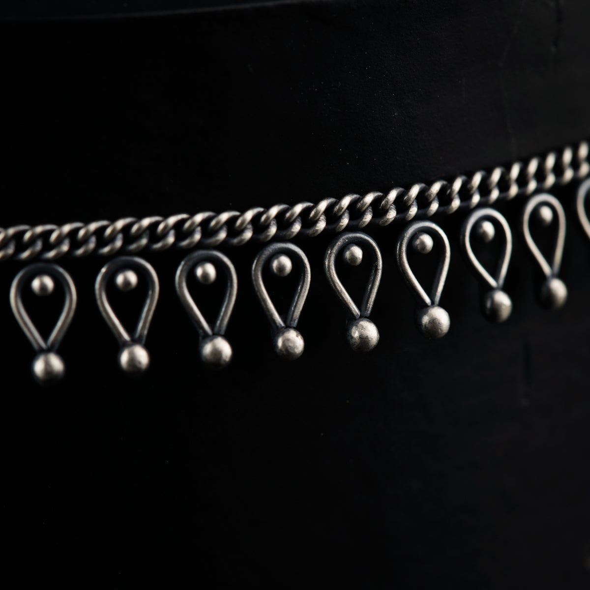 a close up of a belt with metal balls on it