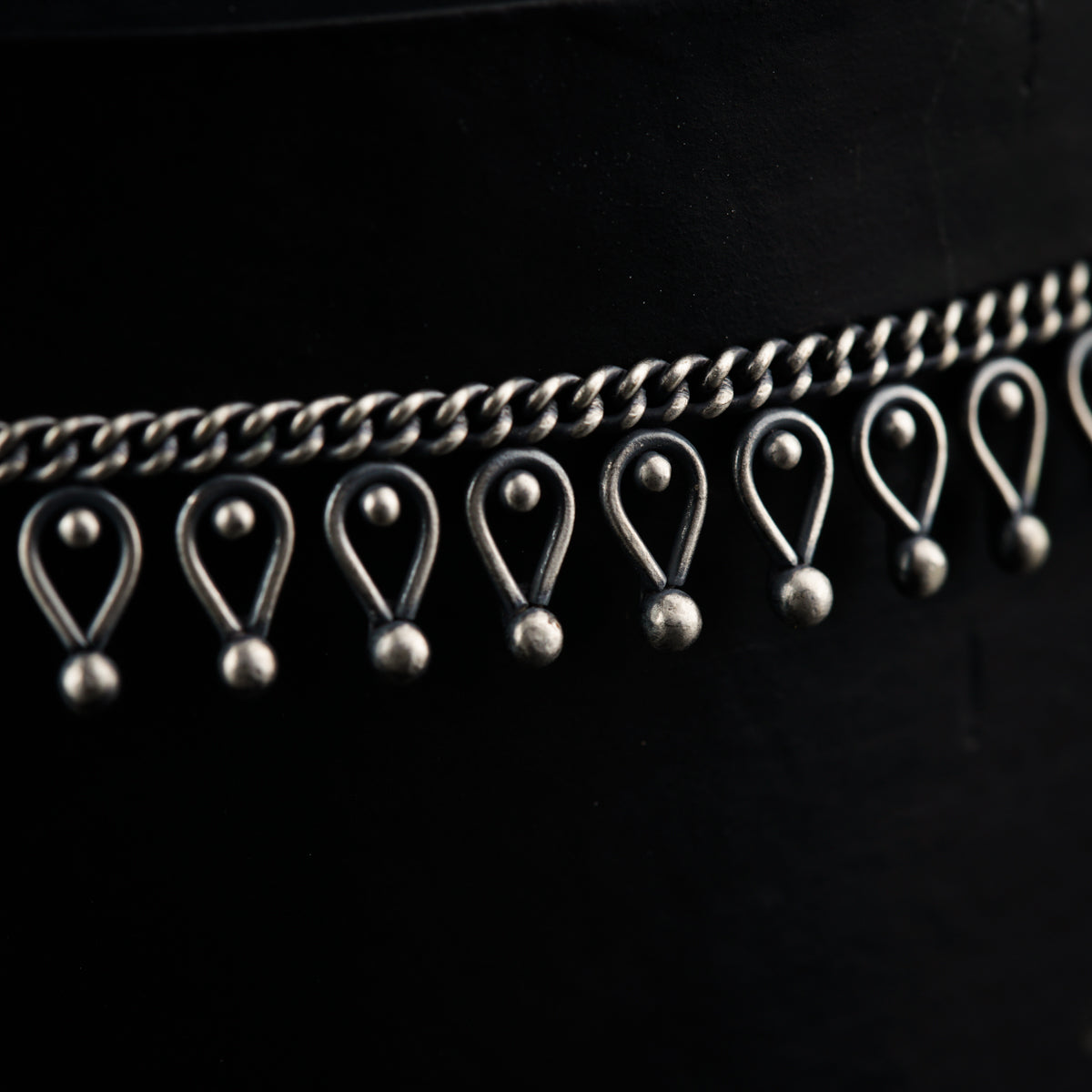 a close up of a belt with metal balls on it