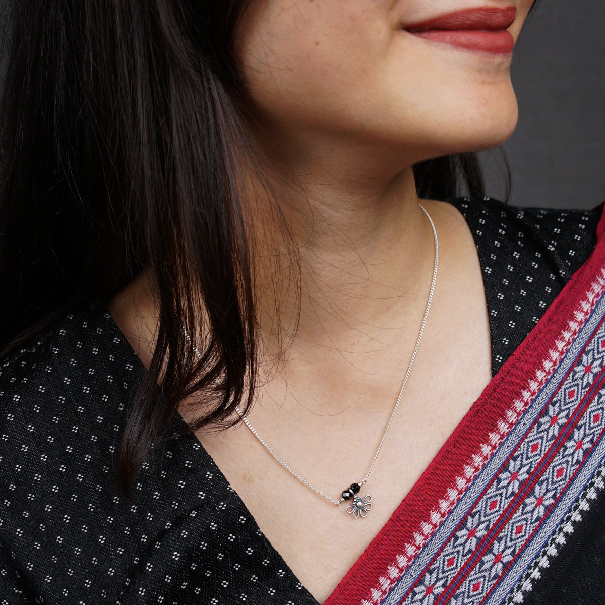 a close up of a woman wearing a necklace