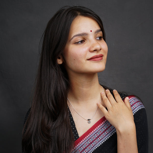 Elegant silver mangalsutra necklace on woman