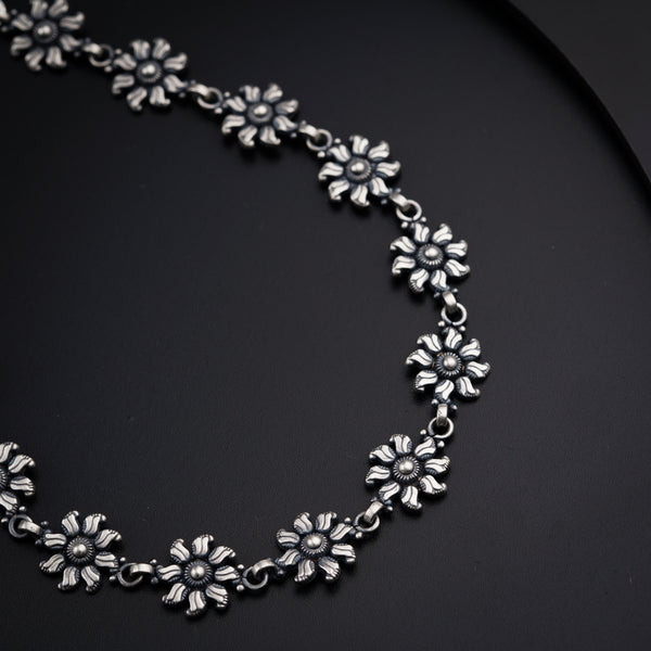 a close up of a necklace on a black surface