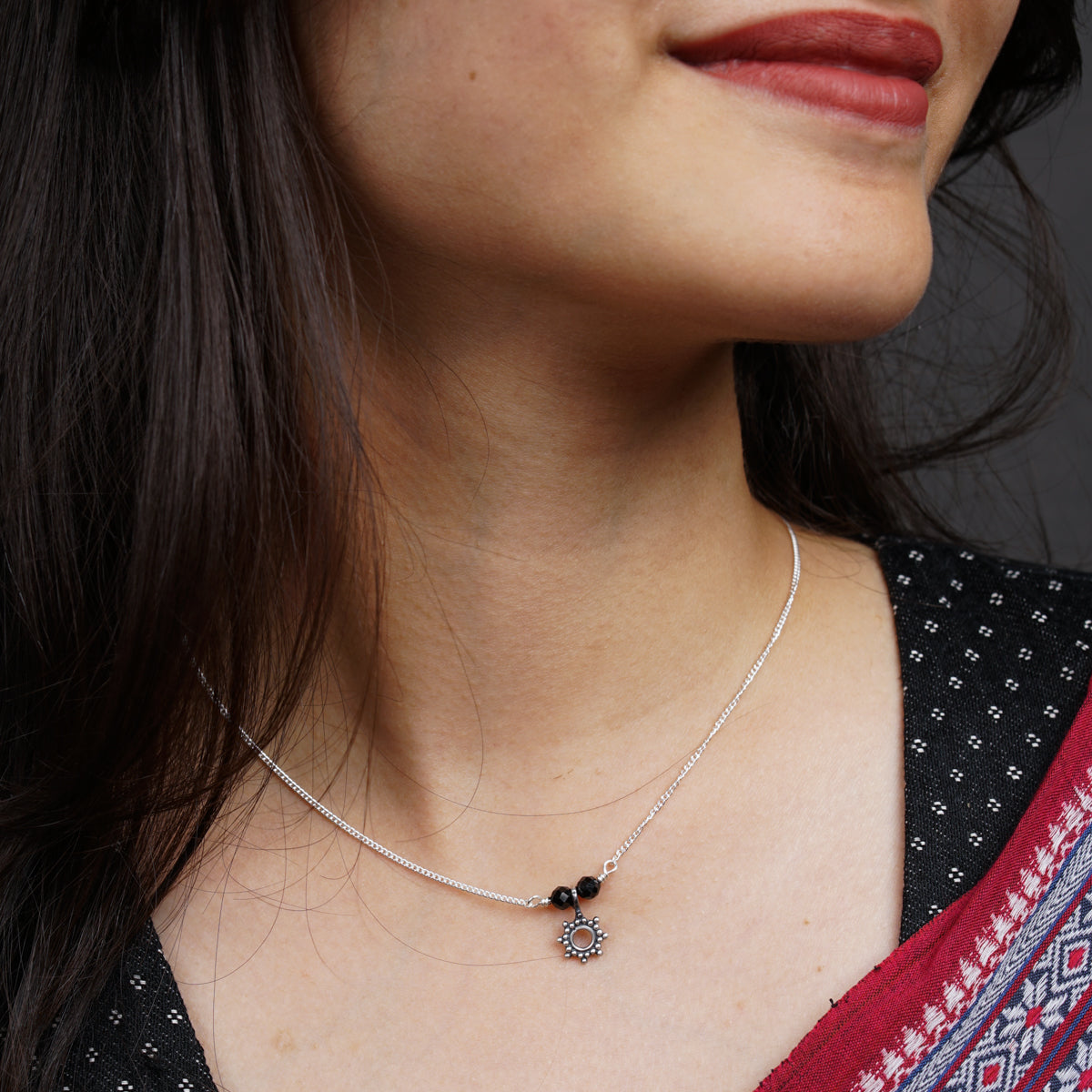 a close up of a woman wearing a necklace