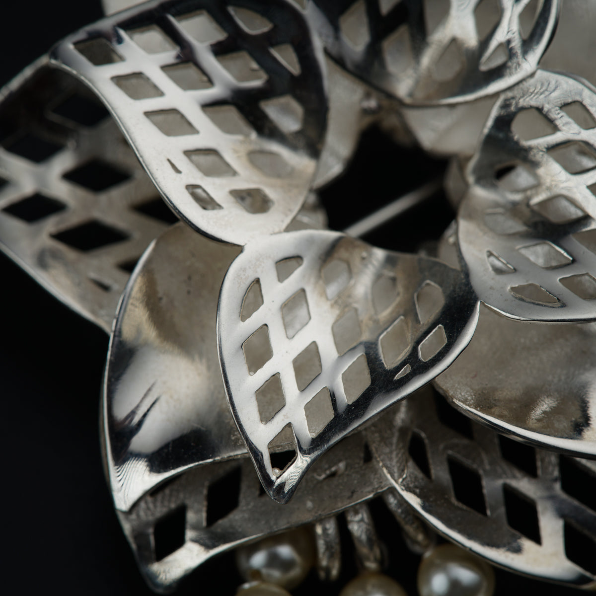 a close up of a metal object on a black background