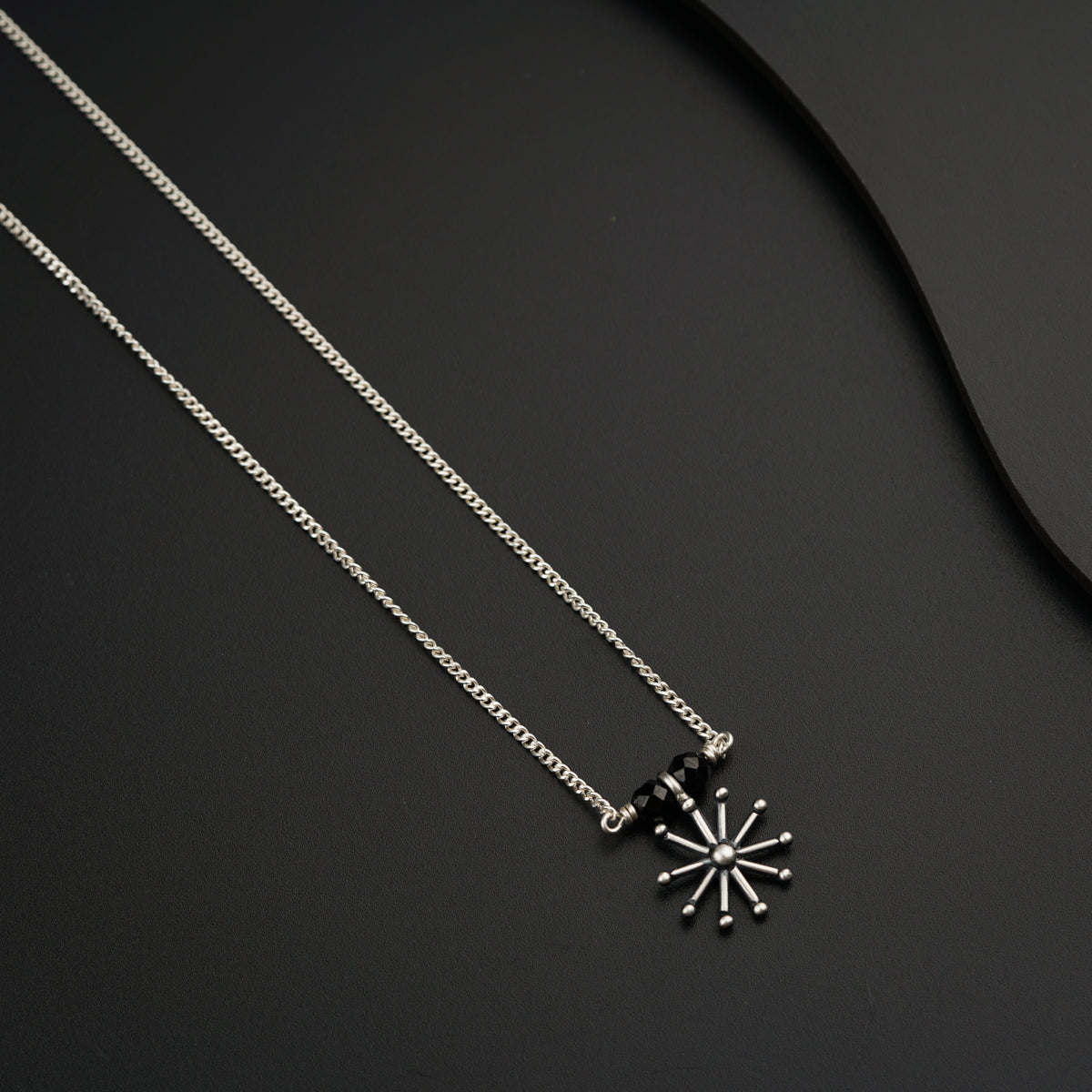 a couple of necklaces sitting on top of a table
