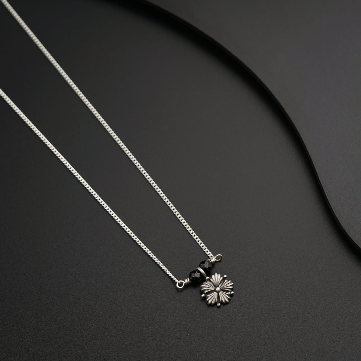 a couple of necklaces sitting on top of a table