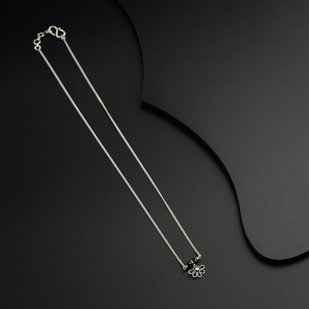 a couple of necklaces sitting on top of a table