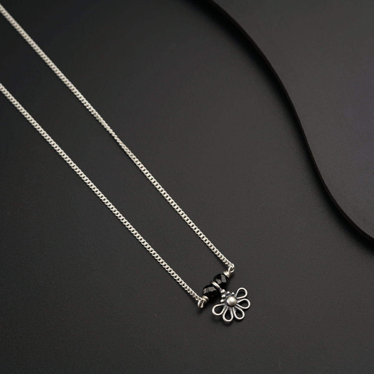 a couple of necklaces sitting on top of a table