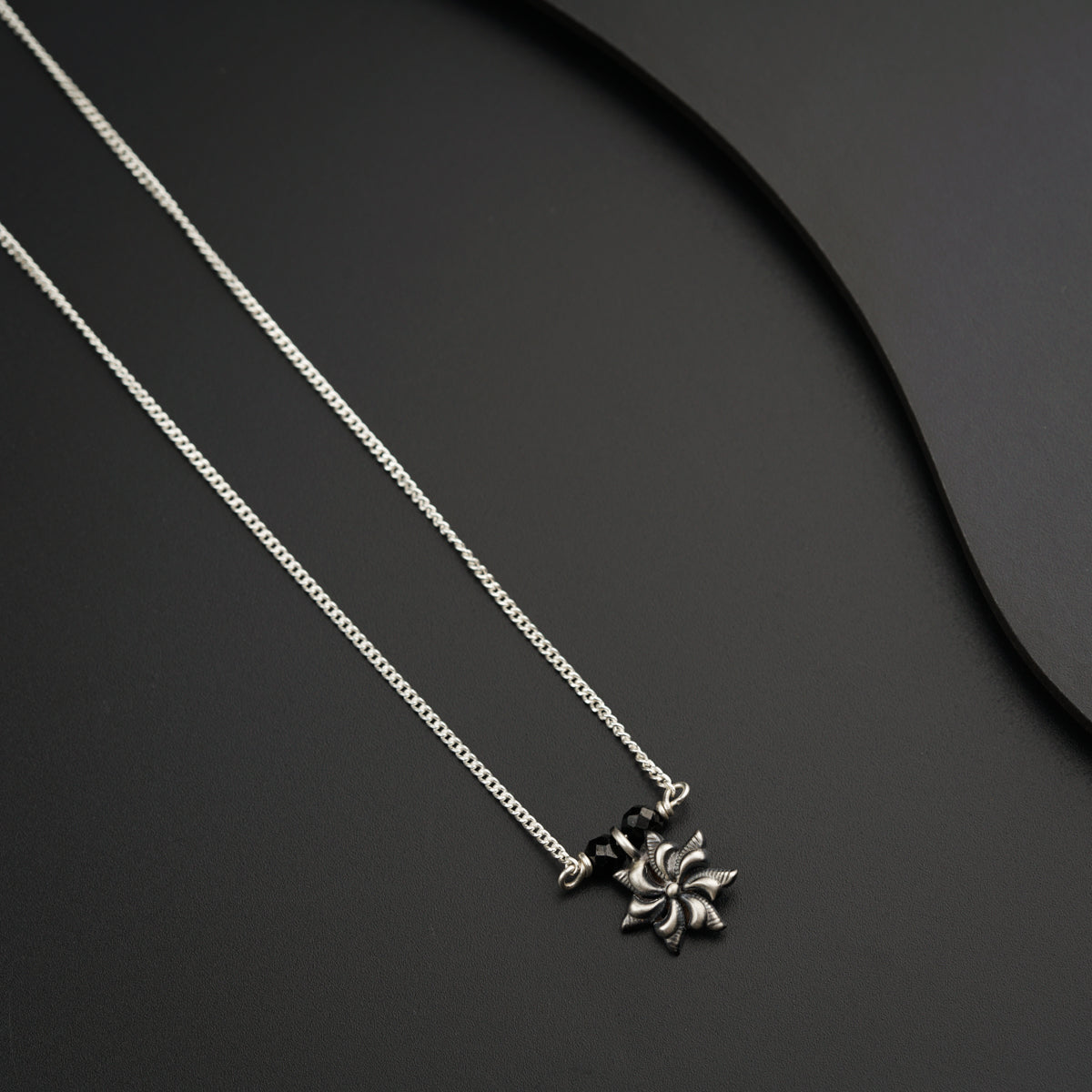 a couple of necklaces sitting on top of a table