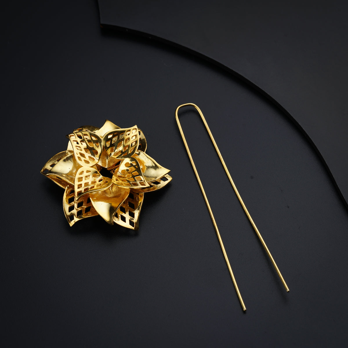 a pair of gold - plated metal hair pins and a gold - plated