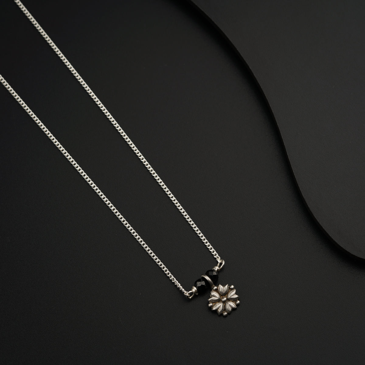 a couple of necklaces sitting on top of a table