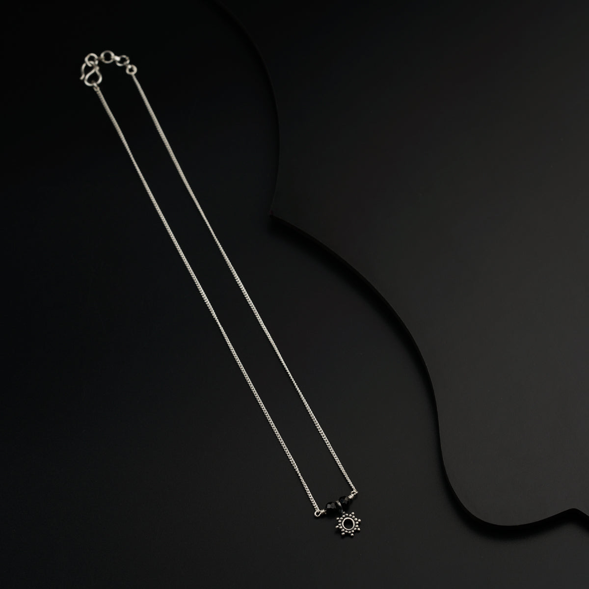a pair of necklaces on a black background