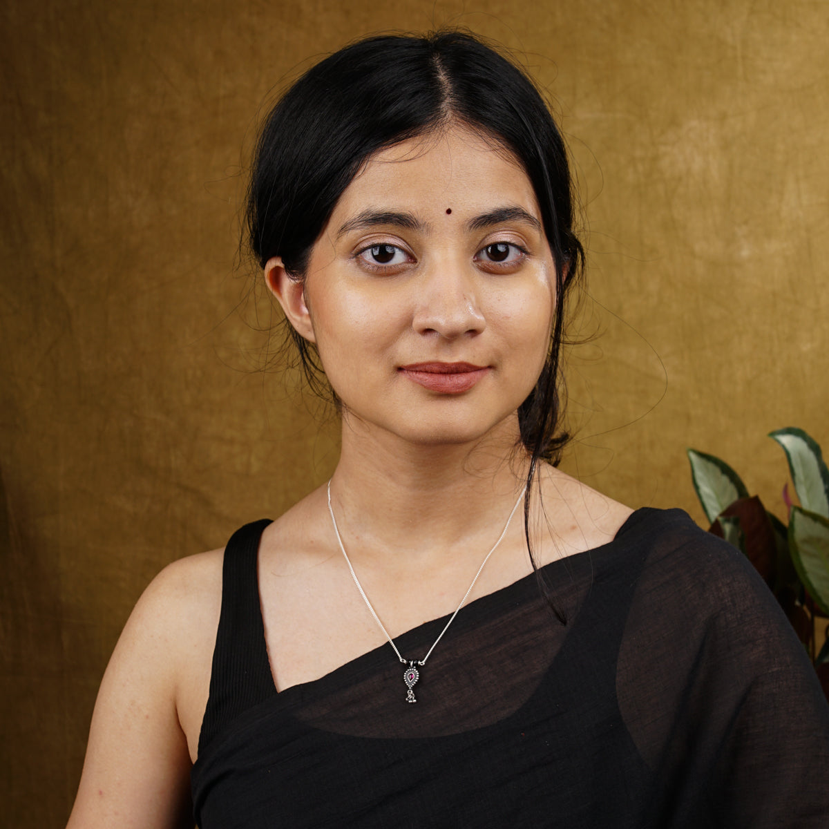 a woman in a black top is posing for a picture