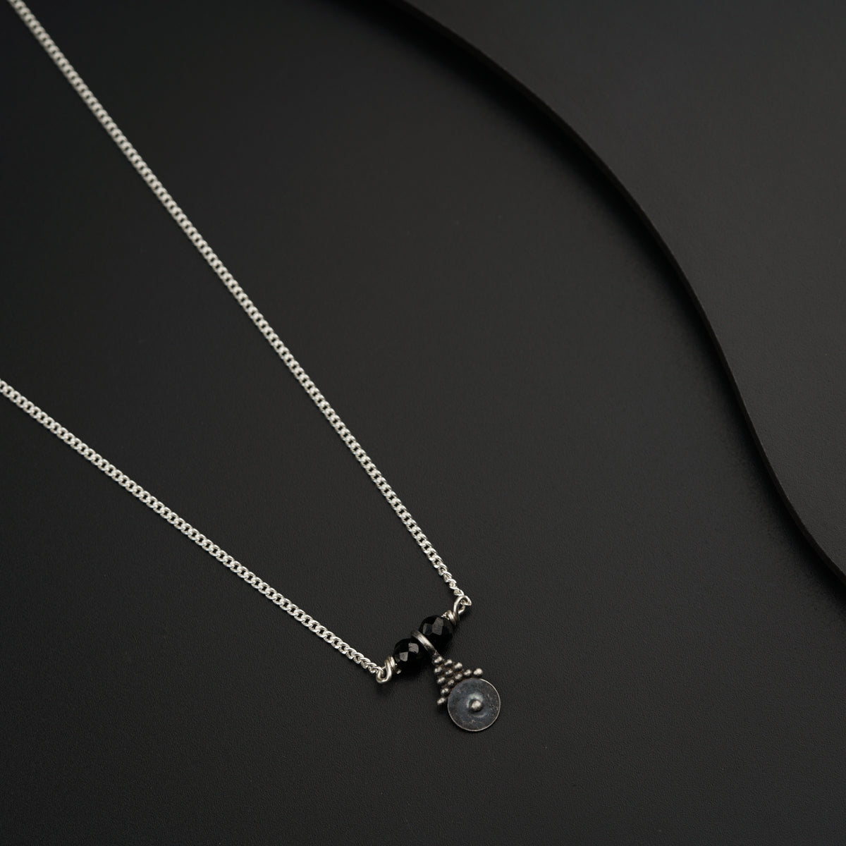 a couple of necklaces sitting on top of a table